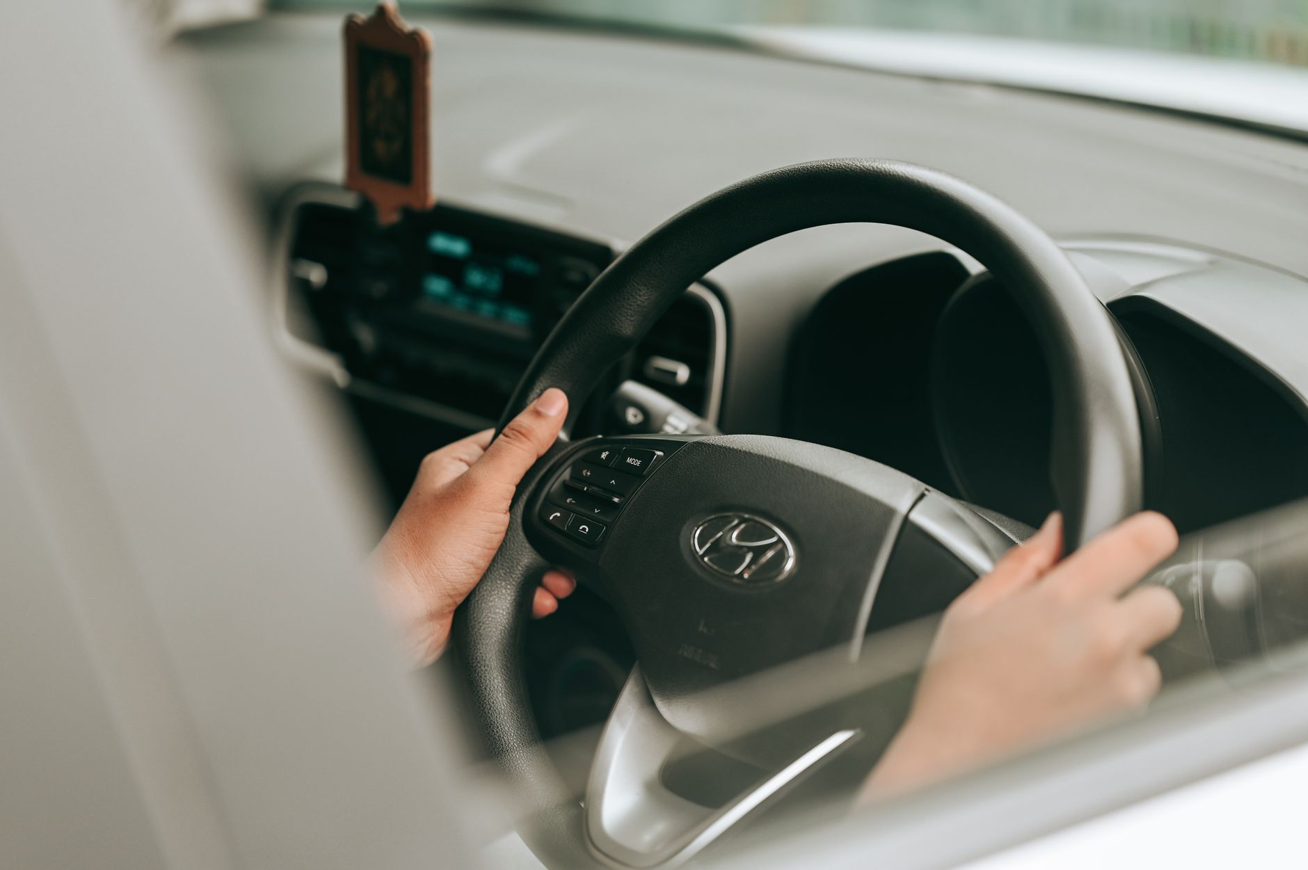 Learner driver's hands on the steering wheel during a driving lesson