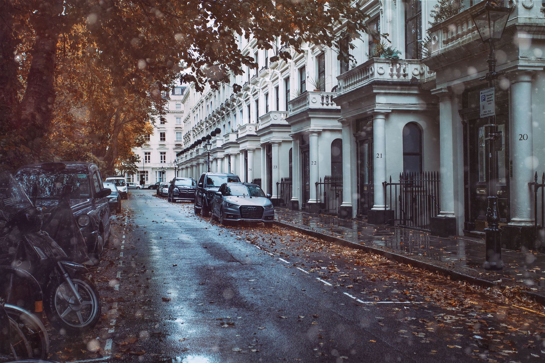 Cars parked along a wet city street, the everyday parallel-parking situation the test is really preparing you for