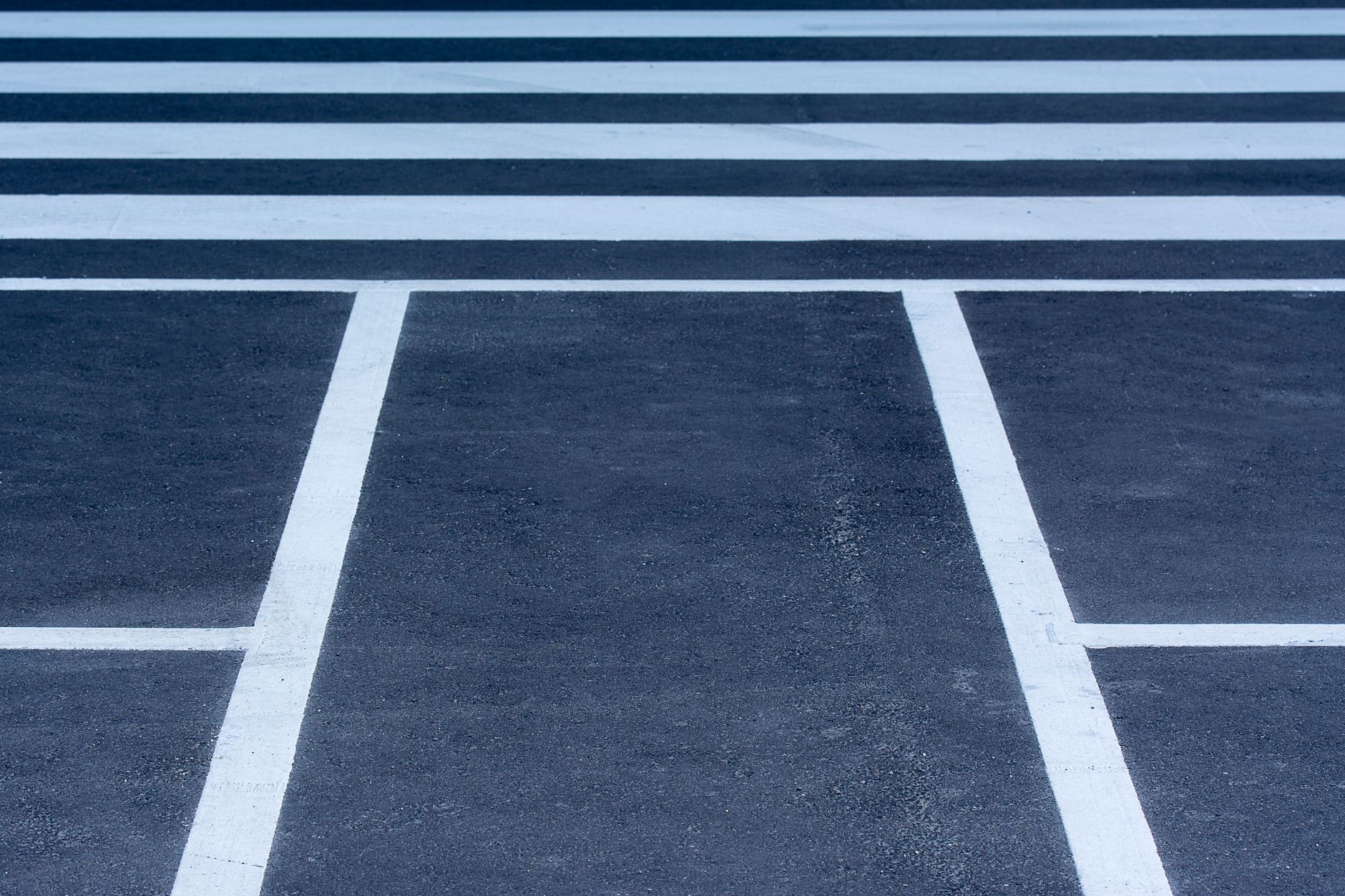 Directional lane arrows painted on a road surface approaching a junction