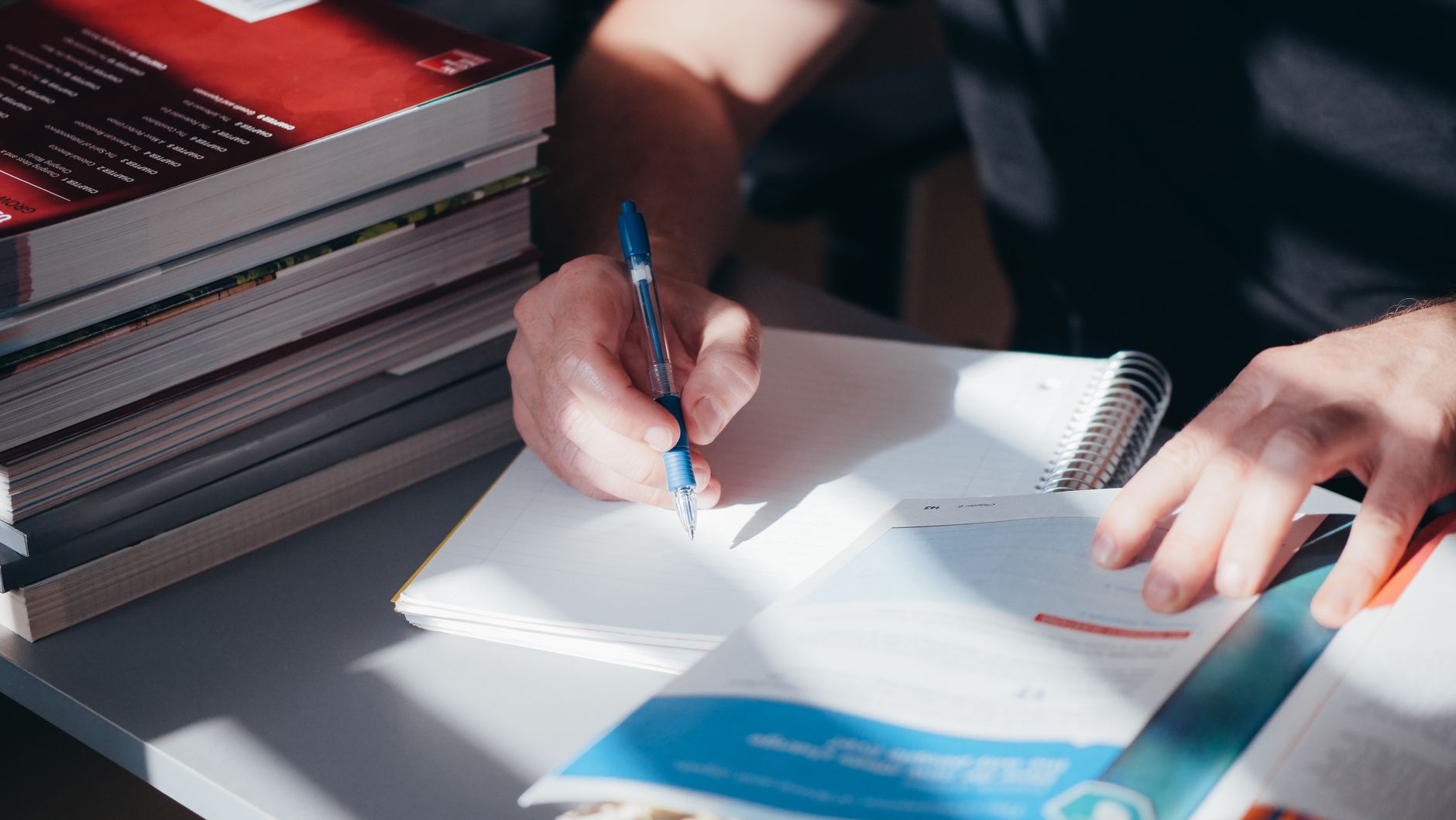 Study notes and books on a desk, the unglamorous work behind passing the theory test first time